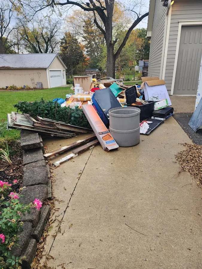 Dumpster being loaded with debris for Commercial Dumpster Rental in White Hall